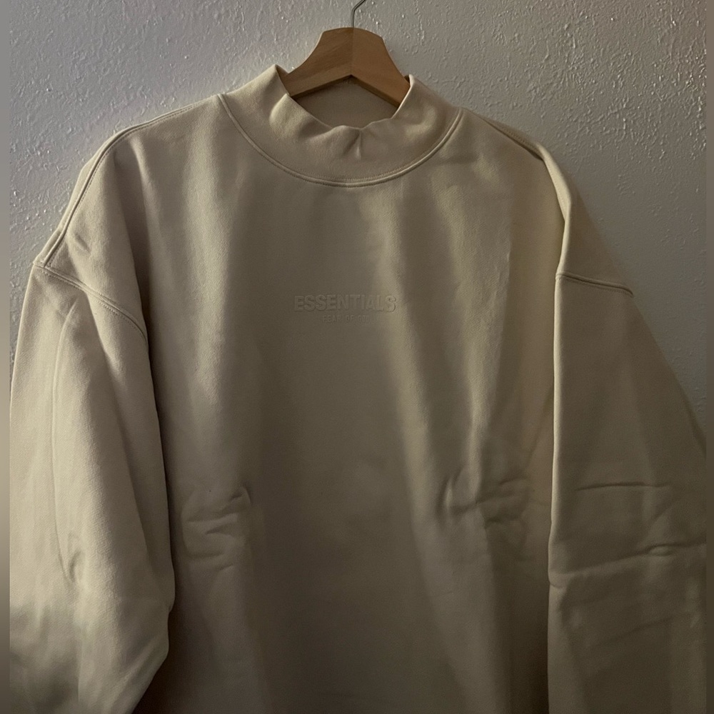 Fear of god essentials eggshell crewneck in size M. NWT runs big